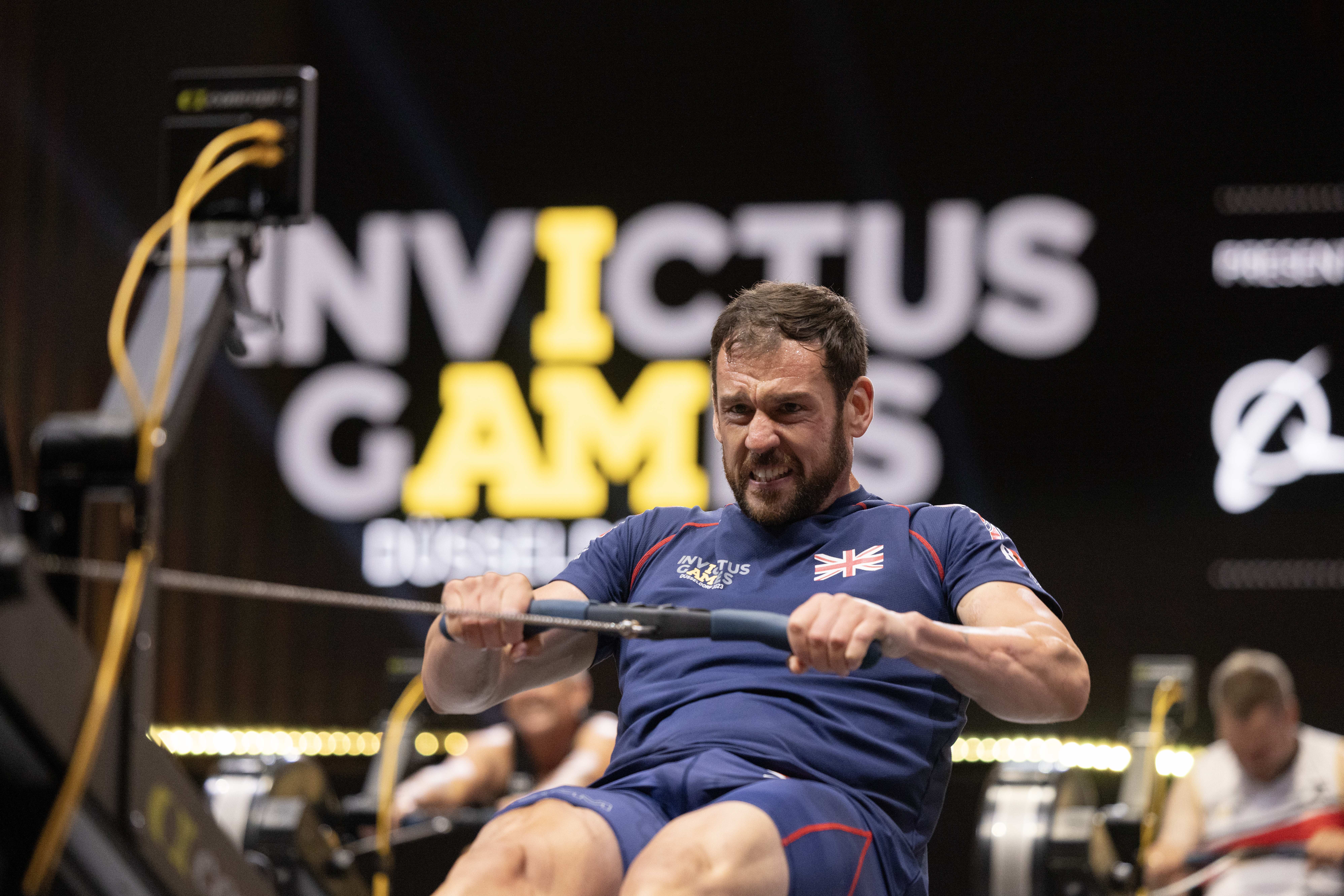 An athlete training on an indoor rowing machine
